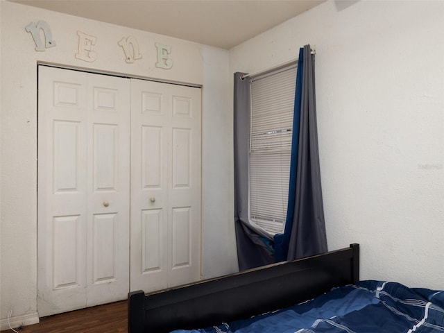 bedroom featuring a closet and dark wood-type flooring