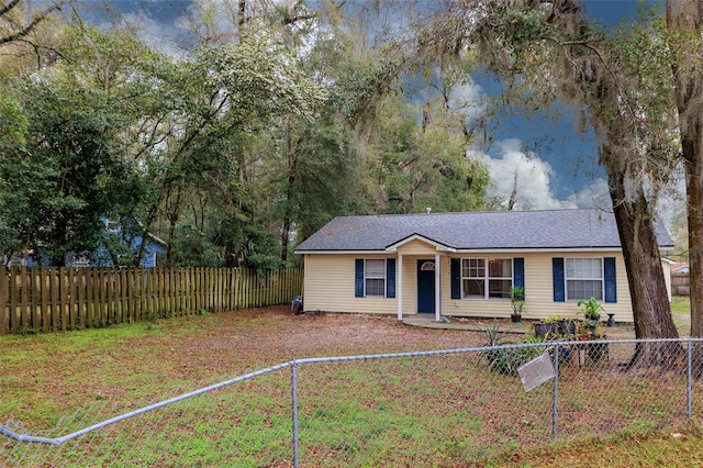 view of front facade featuring a fenced front yard and a water view