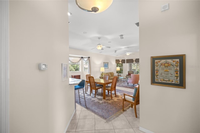 dining space with baseboards and light tile patterned floors