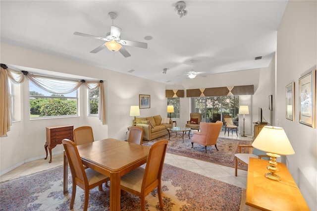 dining room with a ceiling fan, light tile patterned flooring, visible vents, and baseboards