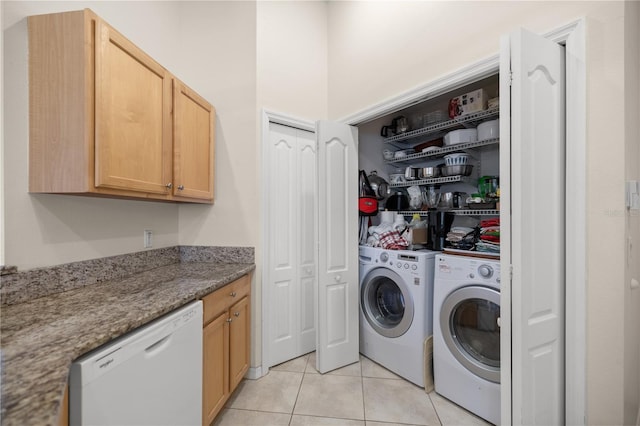 laundry room featuring laundry area, light tile patterned floors, and washing machine and clothes dryer