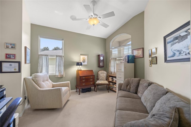 living room with light carpet, ceiling fan, plenty of natural light, and vaulted ceiling