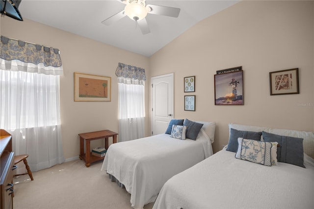 bedroom with a ceiling fan, lofted ceiling, light colored carpet, and baseboards