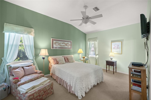 bedroom with lofted ceiling, light colored carpet, visible vents, a ceiling fan, and baseboards