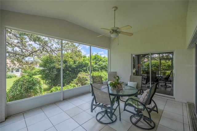 sunroom with a ceiling fan and lofted ceiling