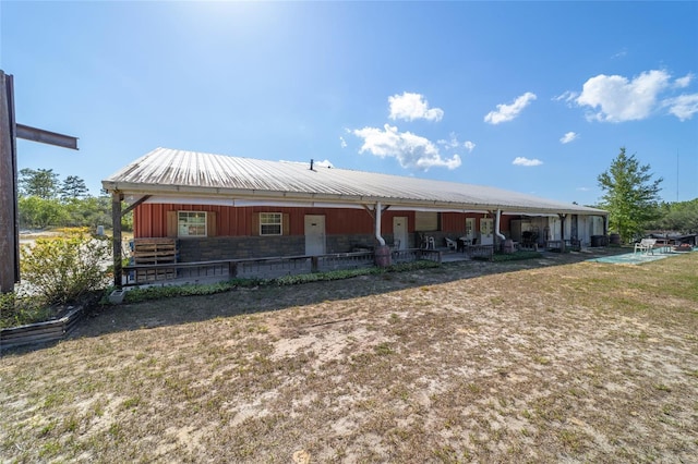 view of front of home featuring metal roof, an outbuilding, and an exterior structure