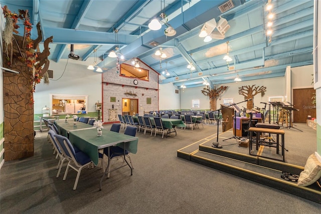 interior space with visible vents, high vaulted ceiling, and beam ceiling