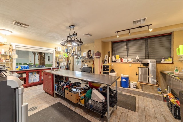 interior space featuring visible vents, track lighting, and wood finish floors