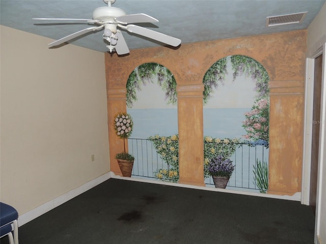 interior space featuring baseboards, visible vents, and a ceiling fan