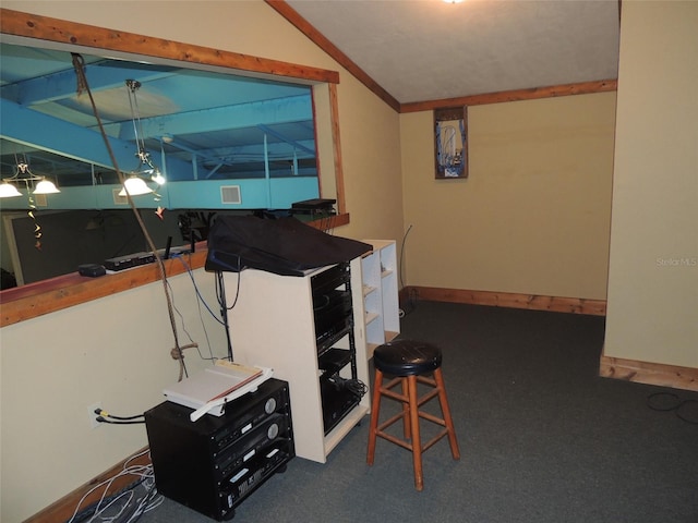 playroom featuring baseboards, dark carpet, and vaulted ceiling