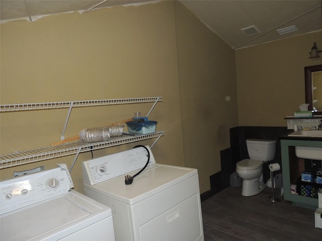 laundry area featuring dark wood-style floors, laundry area, washer and clothes dryer, and visible vents