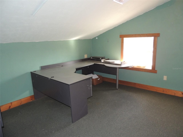 office space with lofted ceiling, baseboards, and dark carpet