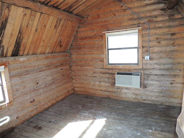 spare room featuring an AC wall unit, wooden ceiling, and log walls