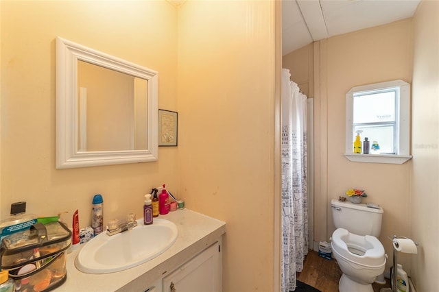 full bath featuring vanity and toilet