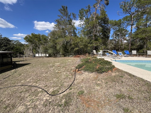 view of yard with an outdoor pool and fence