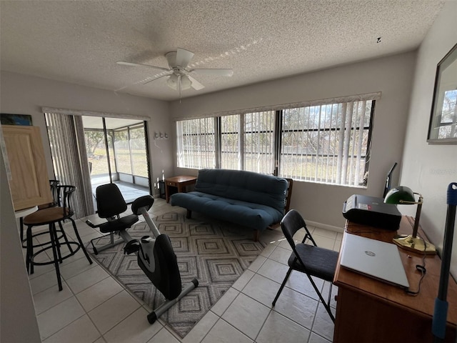 living area featuring ceiling fan, a textured ceiling, and light tile patterned flooring