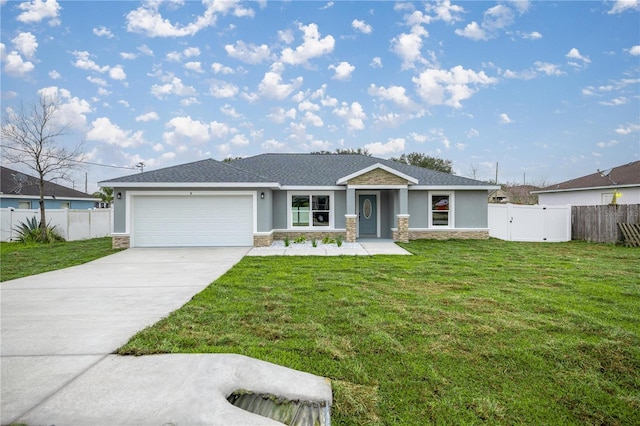 view of front of house featuring stone siding, concrete driveway, fence, and a front lawn