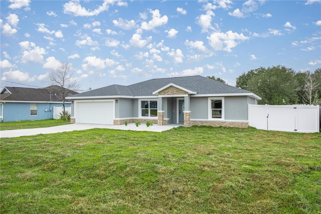 view of front of property featuring driveway, a garage, stone siding, a front lawn, and stucco siding