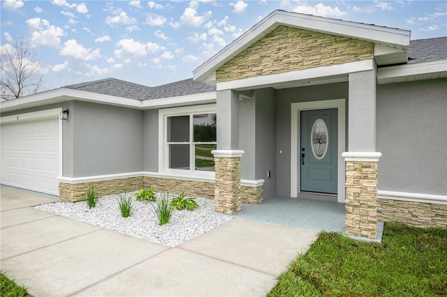 property entrance with a garage, stone siding, a shingled roof, and stucco siding