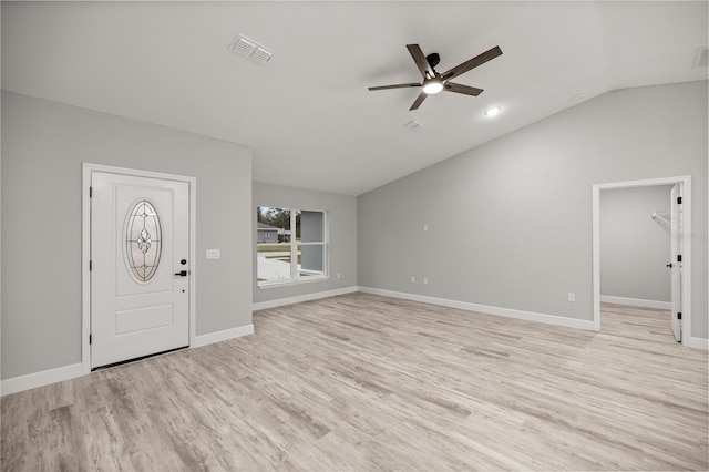 entryway featuring baseboards, visible vents, a ceiling fan, lofted ceiling, and light wood-style flooring