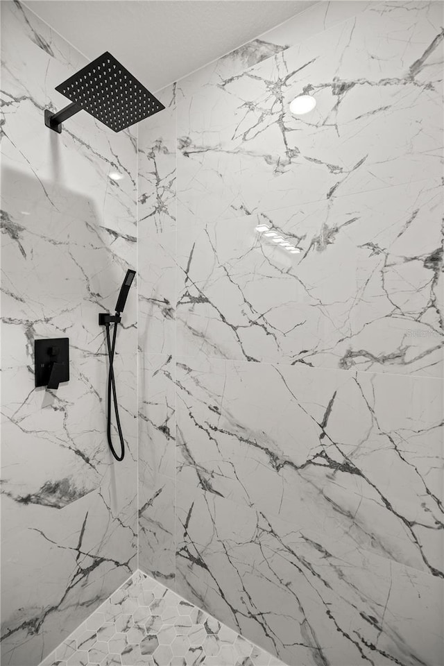 details featuring a marble finish shower