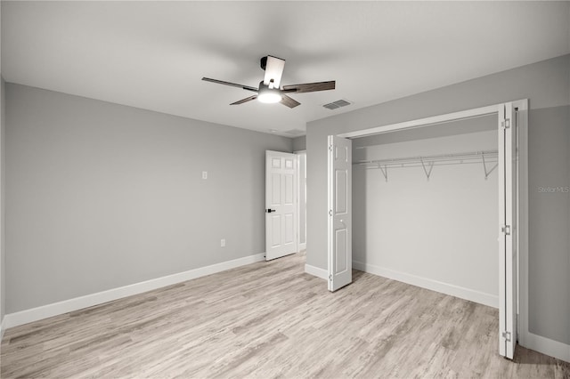 unfurnished bedroom featuring light wood-style floors, a closet, visible vents, and baseboards