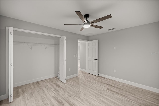 unfurnished bedroom featuring a closet, visible vents, light wood-style floors, a ceiling fan, and baseboards