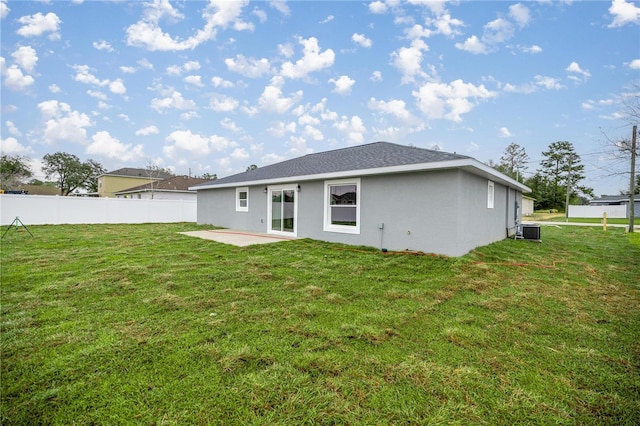 rear view of house with a yard, a patio, cooling unit, and fence