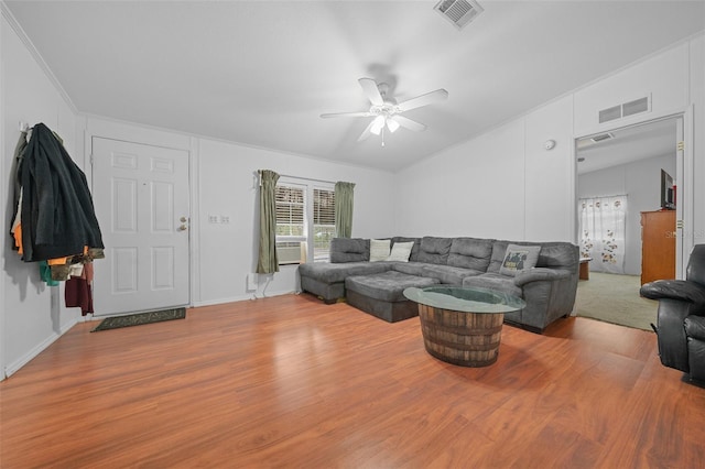 living room with ceiling fan, wood finished floors, visible vents, and crown molding