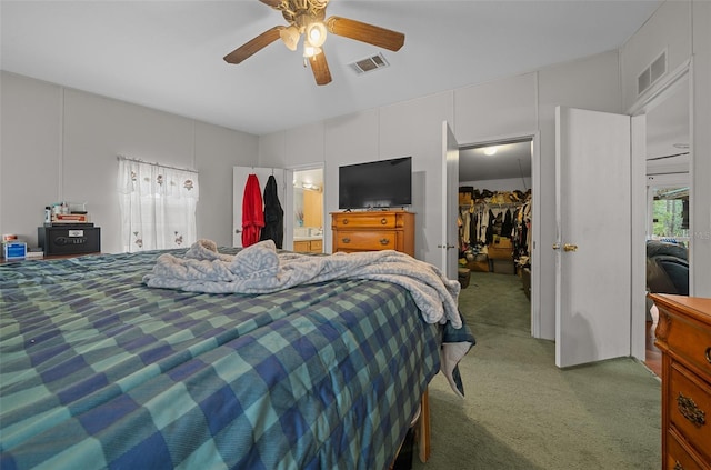 carpeted bedroom featuring a closet, visible vents, ceiling fan, and a spacious closet