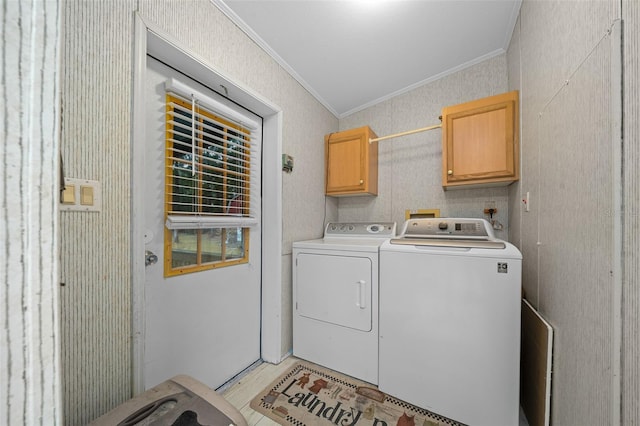 laundry area with cabinet space, light wood-style floors, separate washer and dryer, and crown molding