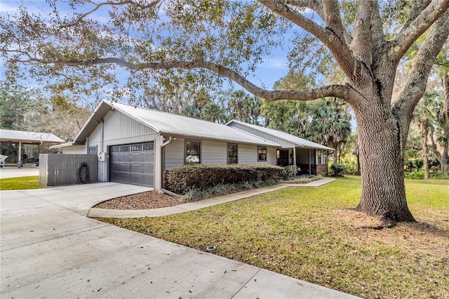 view of home's exterior featuring a garage, concrete driveway, a yard, and metal roof