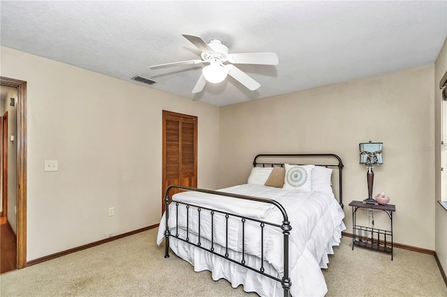 bedroom with carpet floors, a closet, visible vents, and baseboards