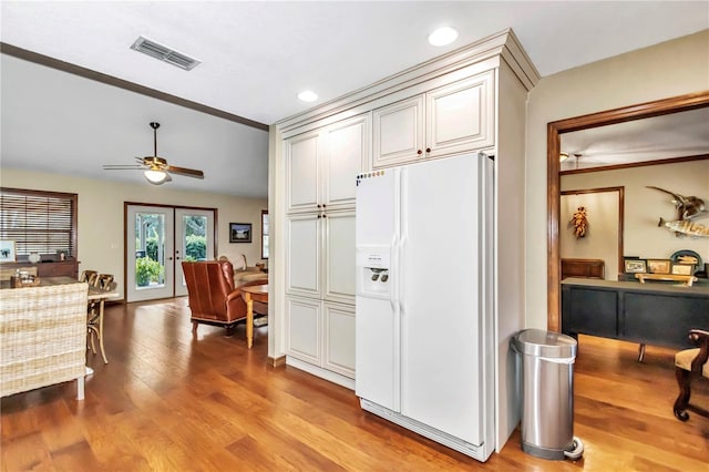 kitchen with recessed lighting, visible vents, french doors, light wood-type flooring, and white fridge with ice dispenser