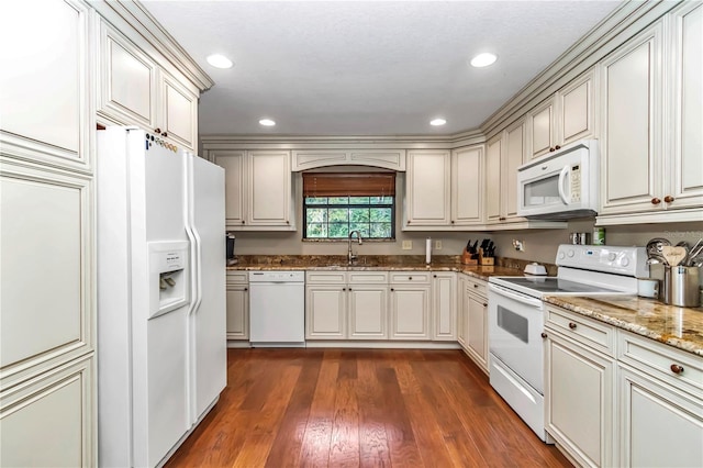 kitchen featuring white appliances, stone countertops, dark wood-style floors, a sink, and recessed lighting