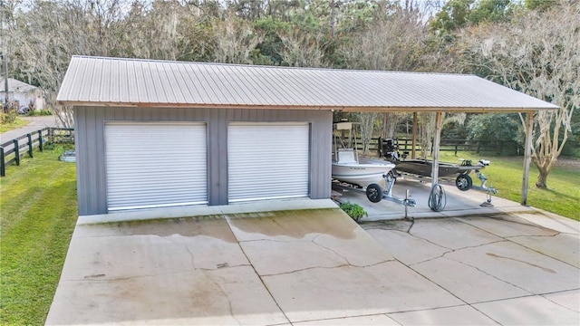 garage with a detached garage and fence