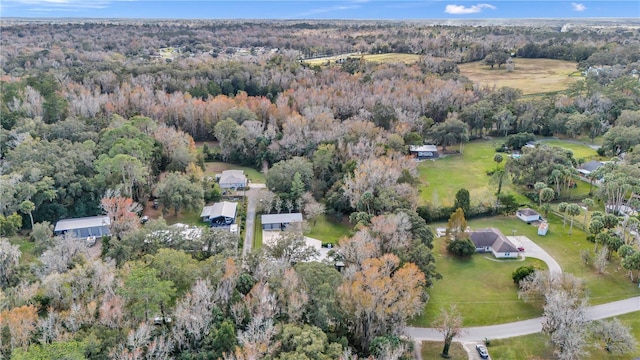 birds eye view of property featuring a forest view