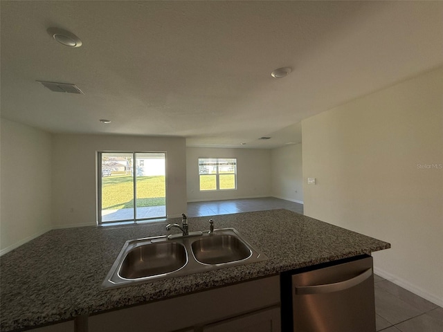 kitchen with a sink, visible vents, open floor plan, tile patterned floors, and dishwasher