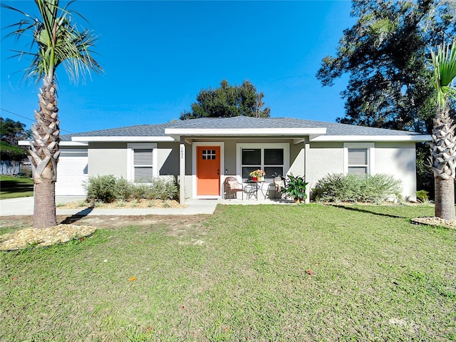 ranch-style home featuring a garage, covered porch, a front lawn, and stucco siding