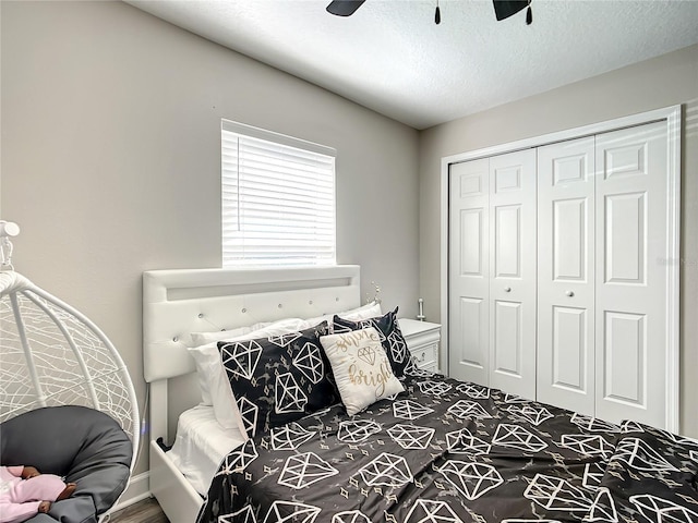 bedroom with a textured ceiling, ceiling fan, and a closet