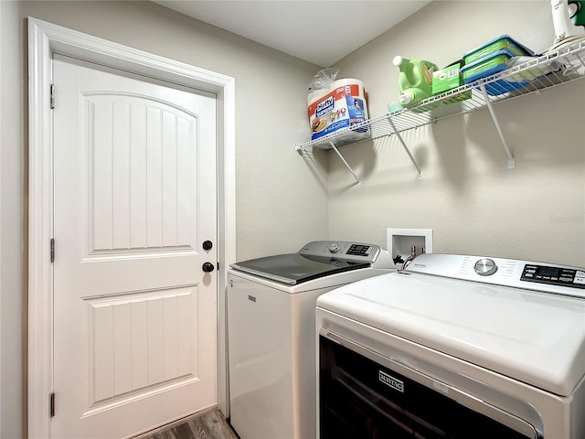 laundry area featuring laundry area, independent washer and dryer, and wood finished floors