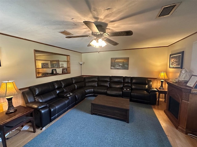 living room featuring visible vents, crown molding, and wood finished floors