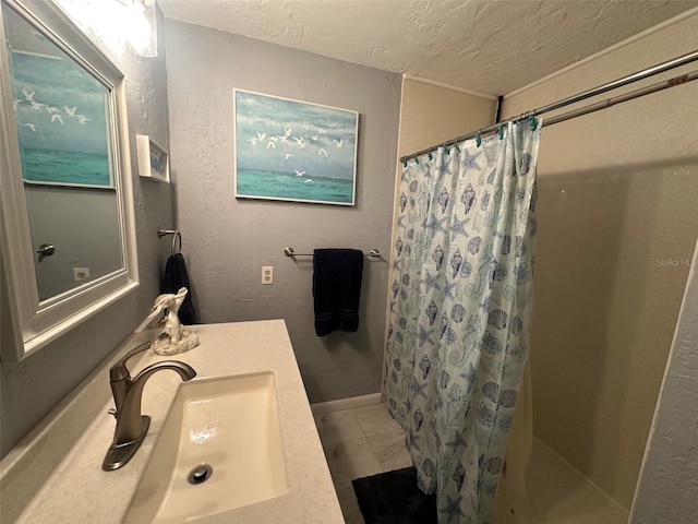 bathroom with a textured wall, tile patterned flooring, a textured ceiling, vanity, and a shower with curtain