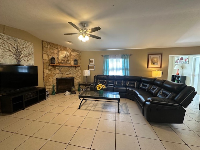 living room featuring light tile patterned floors, a fireplace, lofted ceiling, and a ceiling fan