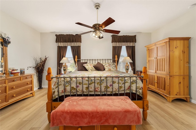 bedroom featuring light wood-style floors, ceiling fan, and multiple windows