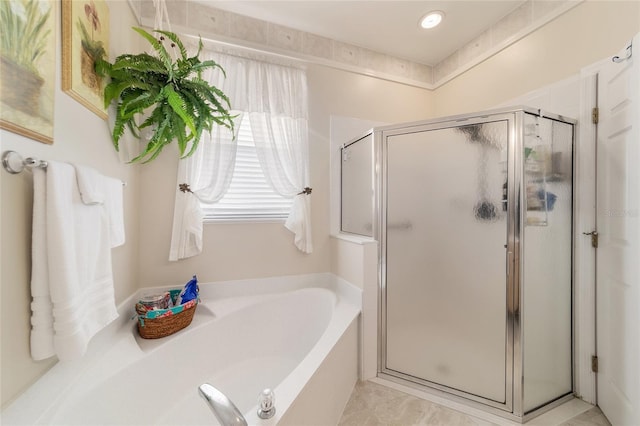 bathroom featuring a garden tub and a shower stall