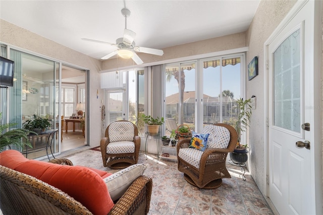 sunroom featuring ceiling fan