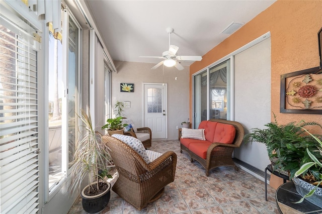 sunroom / solarium featuring a ceiling fan and visible vents