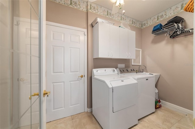 laundry room with cabinet space, light tile patterned floors, baseboards, independent washer and dryer, and a sink