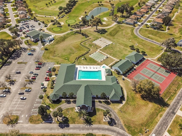 drone / aerial view featuring view of golf course and a water view